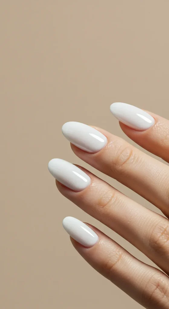 Pure white nails with a smooth, glossy finish, embodying a sleek and sophisticated minimalist aesthetic.

