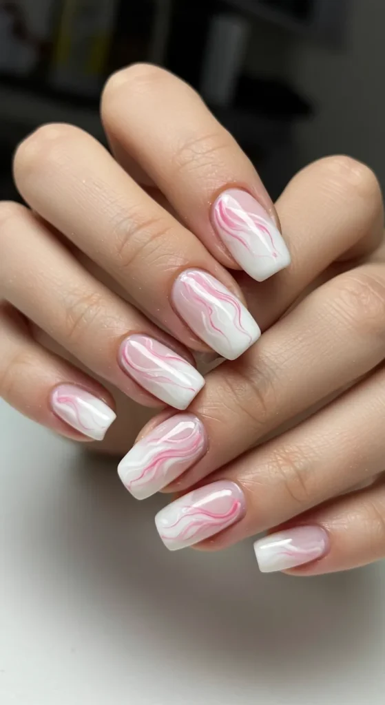 Soft white and pastel pink swirls blend seamlessly, creating an elegant marble effect with a refined touch.

