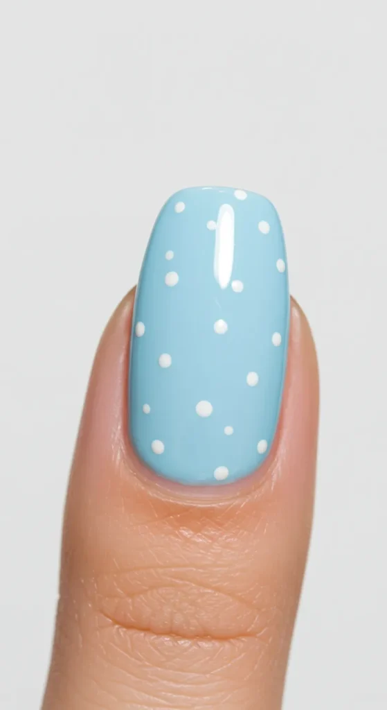 A nude or pastel base adorned with small white polka dots, creating a playful and fresh springtime look.

